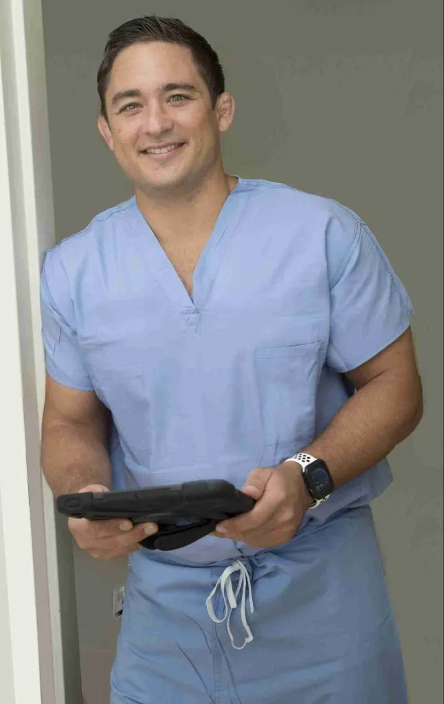 Dr. Paul Norio Morton listening during an orthopedic consultation